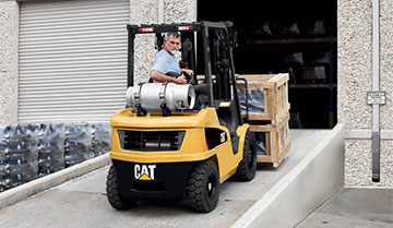 Man Reversing down a Warehouse Ramp on a Small IC Cat Lift Truck